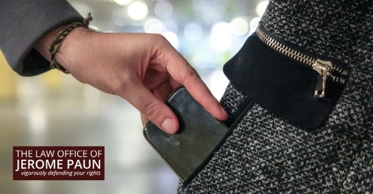 thief stealing a phone from someone